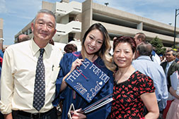 Photo of graduate with her parents. Link to Gifts of Retirement Plans